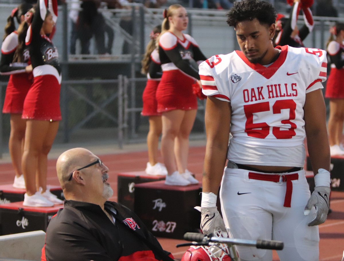 Oak Hills offensive line coach Nick Monica chatting it up with Paki Finau (53).